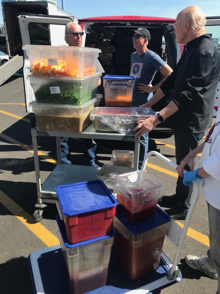 chefs loading perishable food into Bracken's Kitchen van