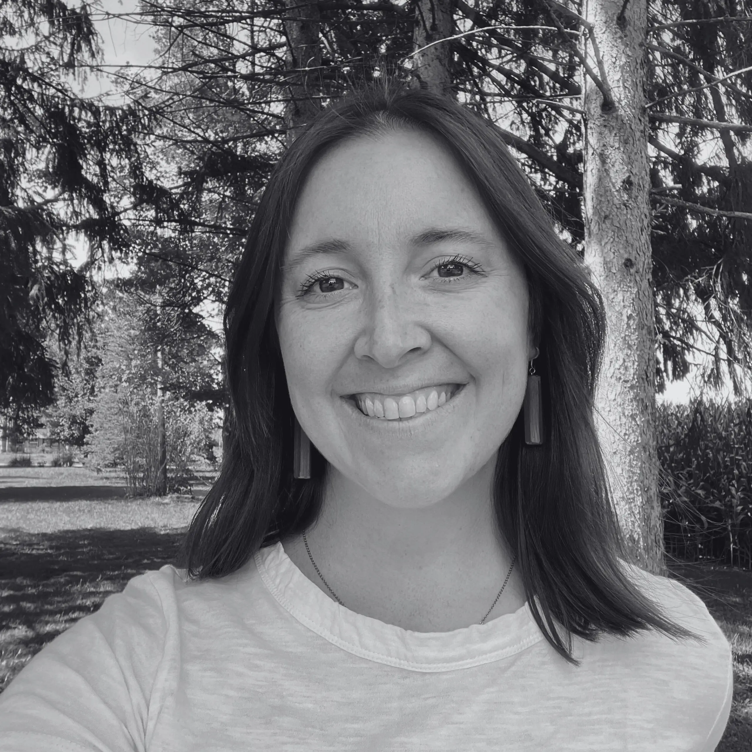 black and white photo of Ashley Dulaney smiling at the camera