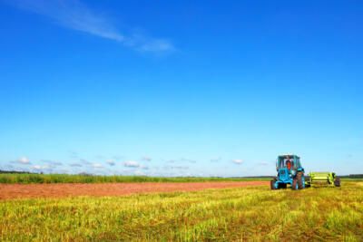 tractor driving across agricultural farm field