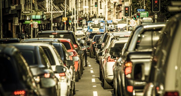 cars wait in gridlock on a busy street