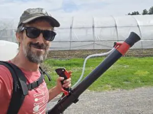Farmer Dan Perkins with a foliar sprayer.