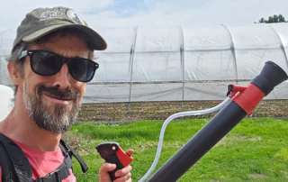 Farmer Dan Perkins with a foliar sprayer.