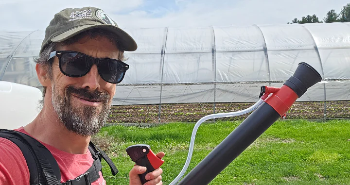 Farmer Dan Perkins with a foliar sprayer.