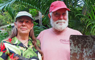 Farmers Kathy Vass, holding a chicken, and Rob Vass, holding a shovel