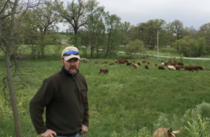 Jack Gieger speaking in front of his cattle. 
