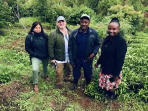 OFRF Board Member Carrie-Anne at a farm in Kenya with three other people.
