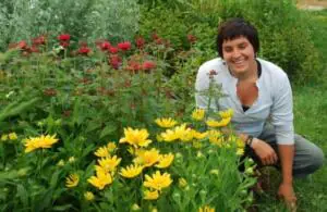 OFRF Board Member Carrie-Anne Palmeri smiling near a bed of flowers.